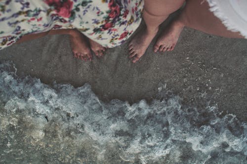 Free People Standing on the Beach Stock Photo