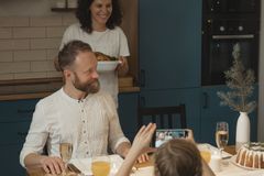 A joyful family gathering, celebrating with a festive holiday meal indoors.