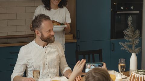 A joyful family gathering, celebrating with a festive holiday meal indoors.