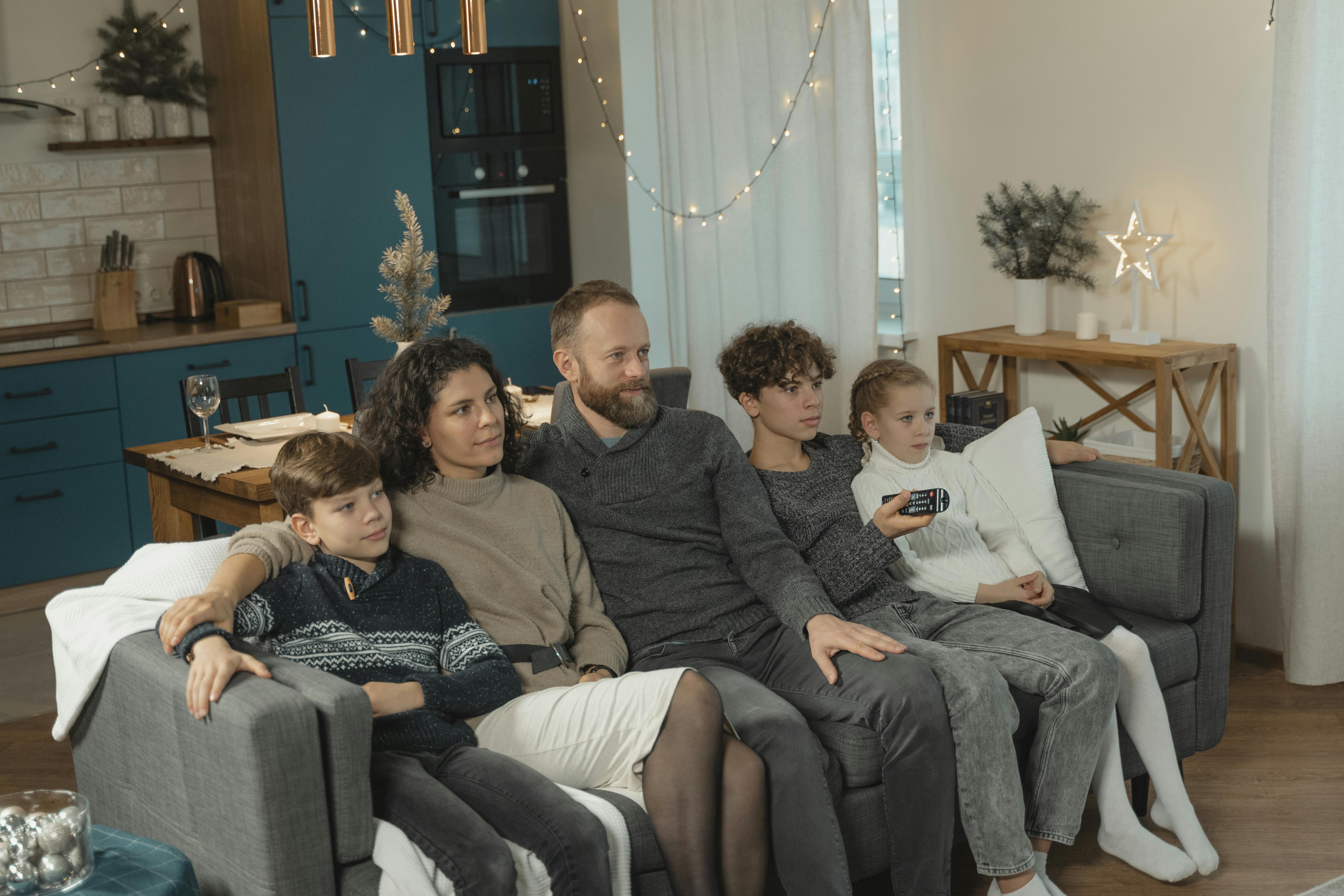 A cozy family relaxing in their warm home during an Indiana winter - "I'm looking for quotes on a budget-friendly furnace replacement in the Greenville, Indiana area."