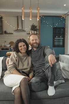 Smiling couple enjoying cozy time together in a modern living room.