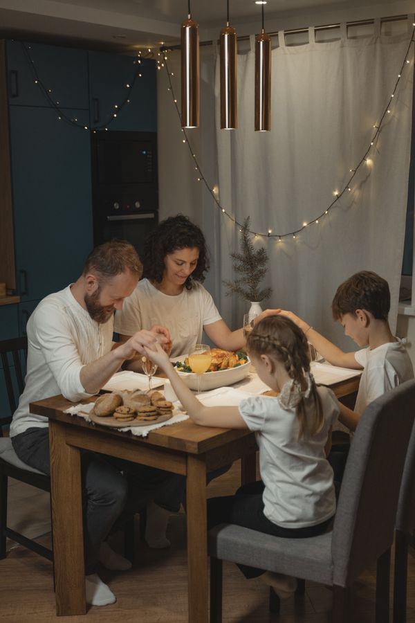 A family holding hands in prayer