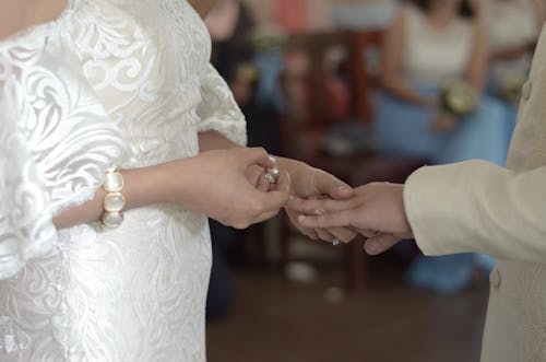 A Couple Getting Married Wearing Their Wedding Rings