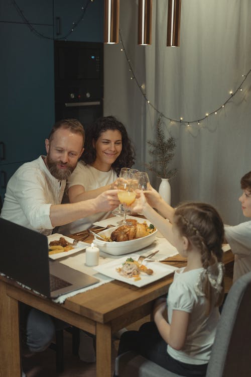 A Family Sharing a Toast Via Video Calling