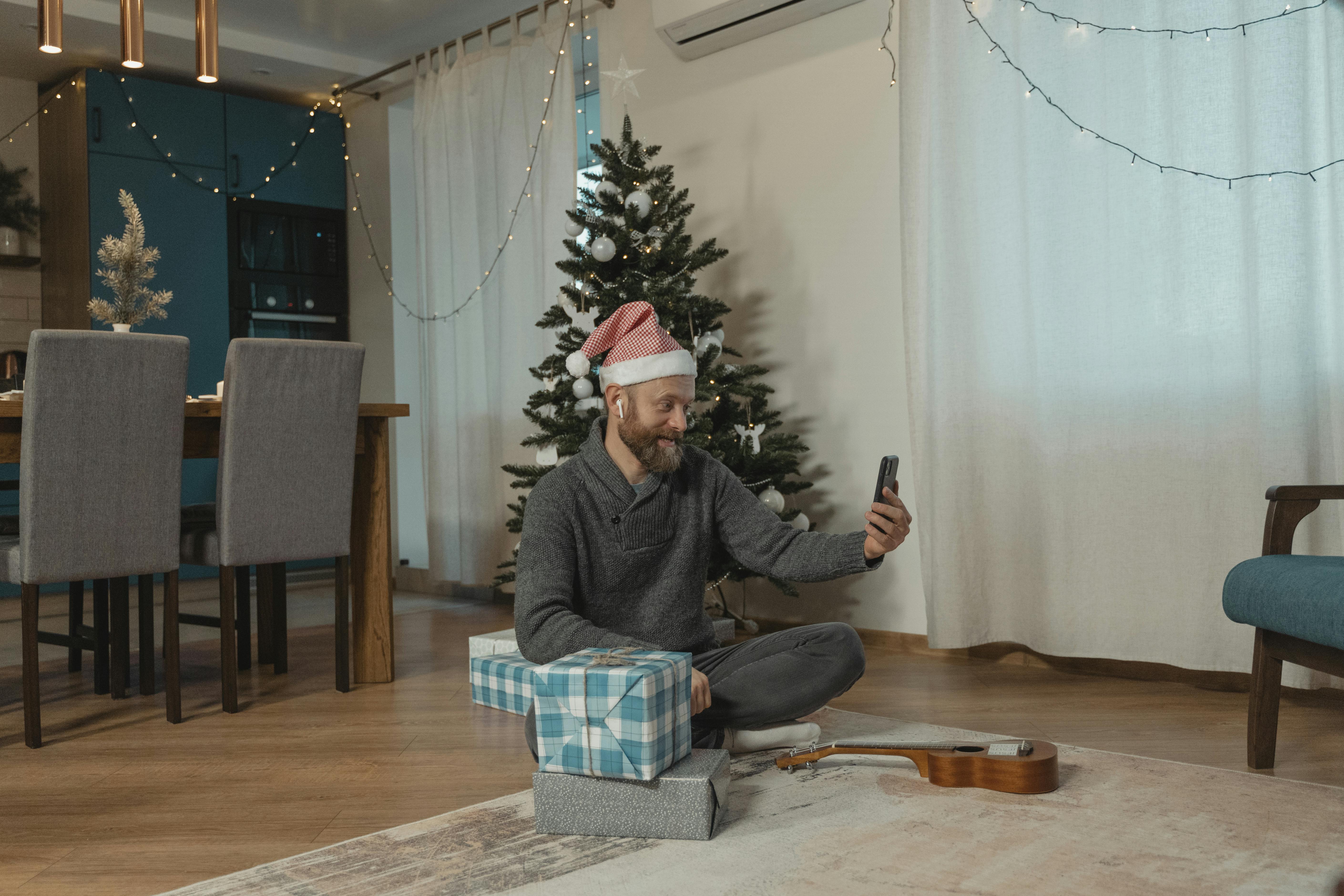 a man in gray sweater wearing a santa hat