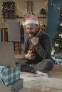 A Man in Santa Hat Holding a Ukulele