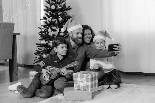 Free A Family Taking a Groupie in Front of the Christmas Tree Stock Photo