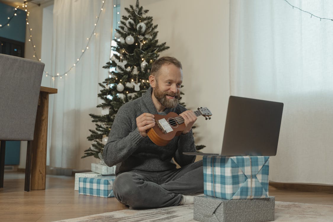 A Man Showing His Ukulele in a Video Call