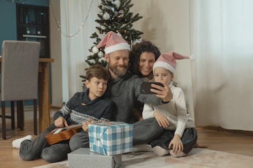 Free A Family Engaged in a Vide Call Using a Smartphone Stock Photo