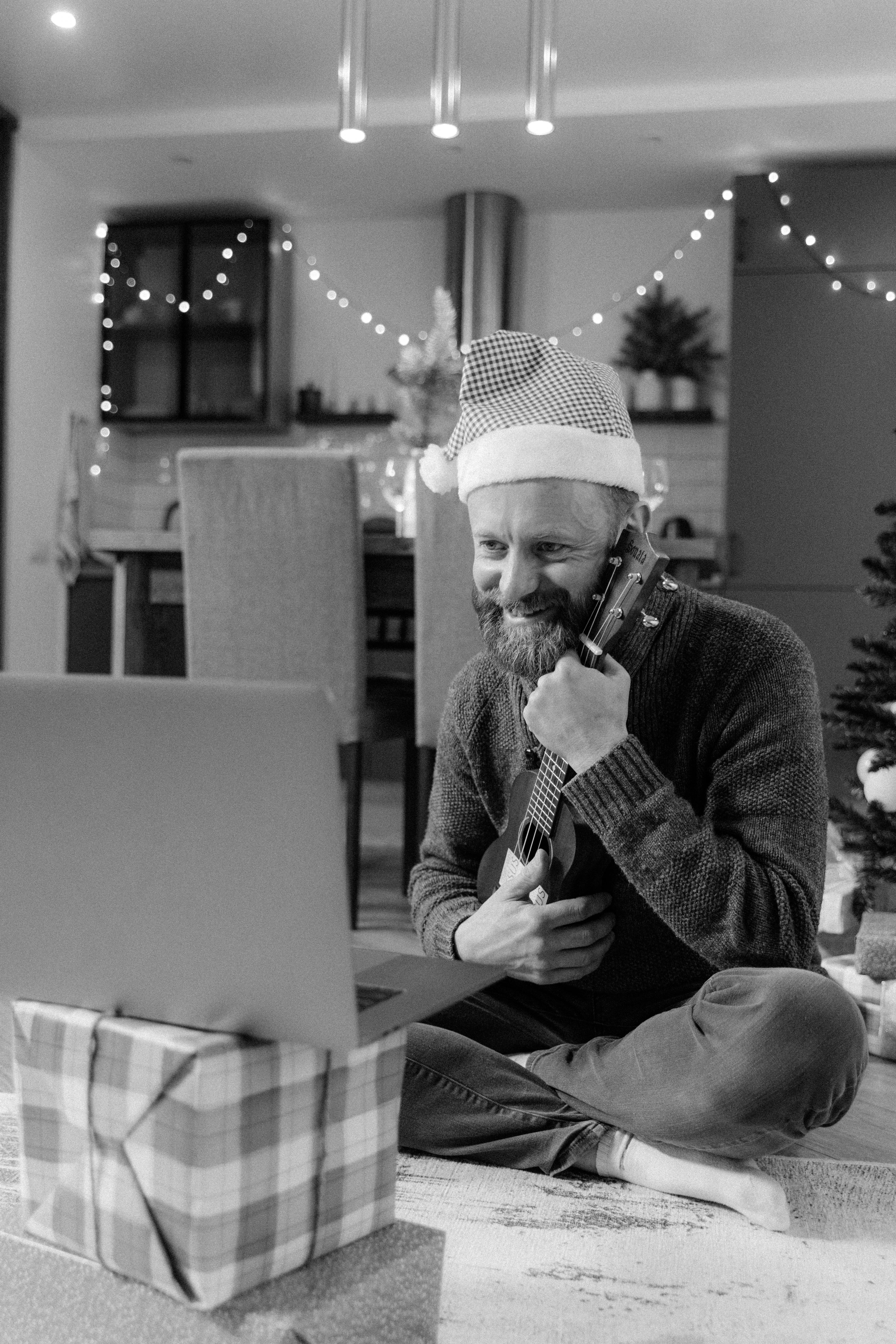 man in sweater and hat sitting on chair