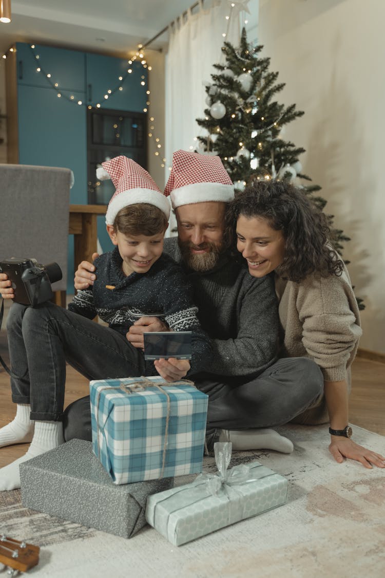 A Family Looking At A Photograph