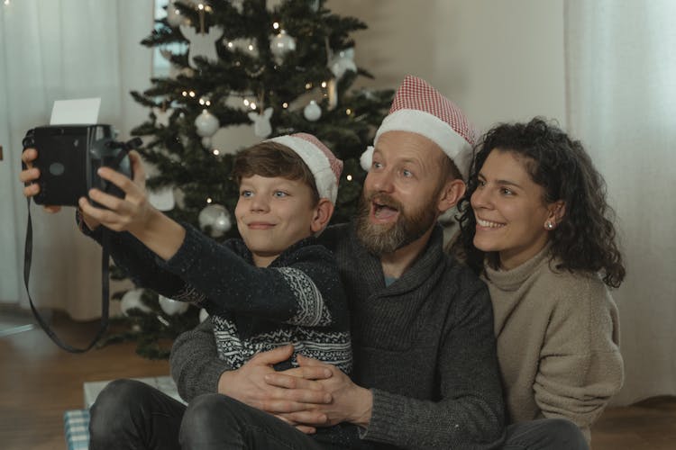 A Family Having A Groupie Picture With A Polaroid Camera