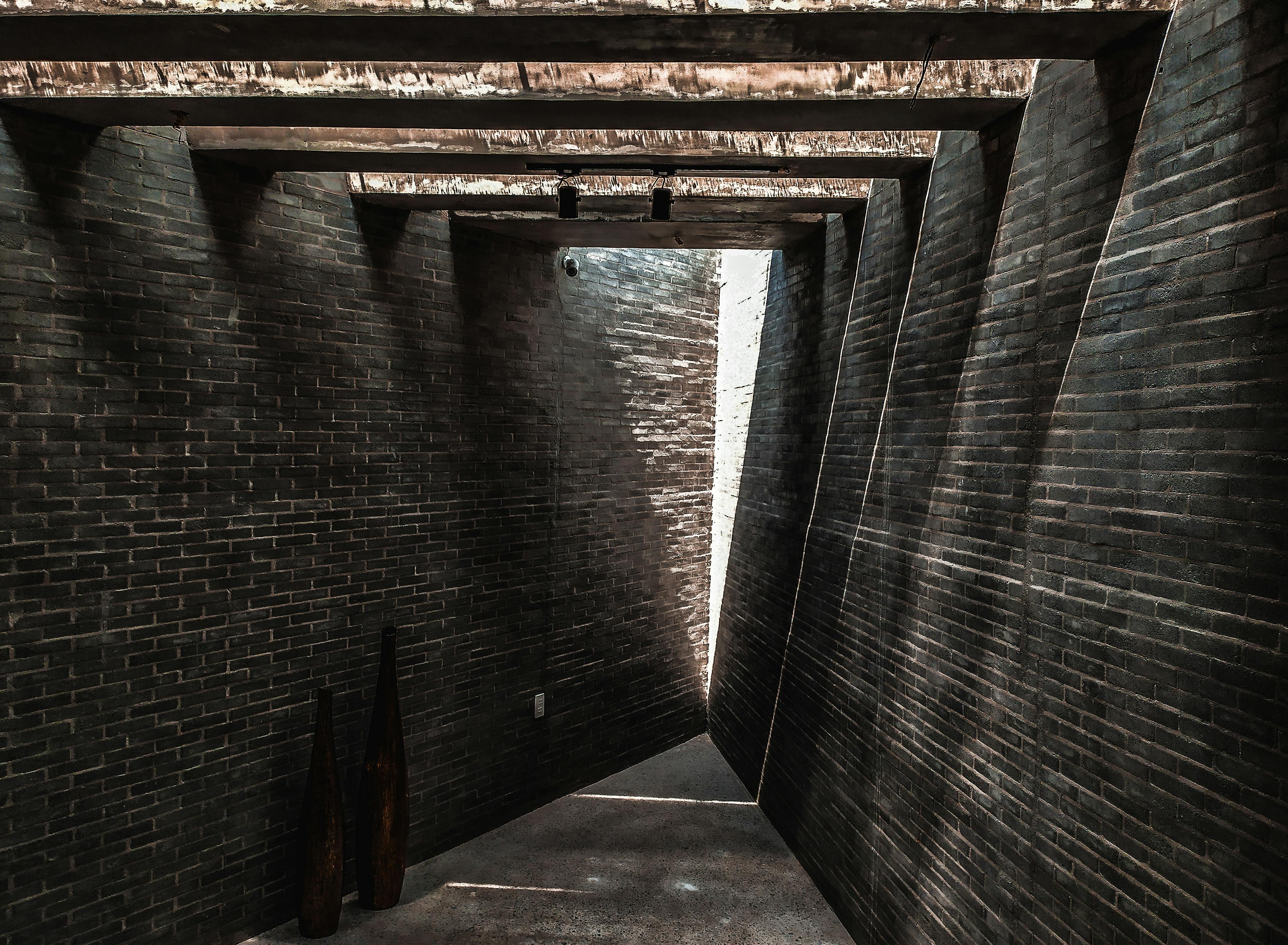 Free A modern brick architecture with dynamic shadows and rustic beams in Thủ Dầu Một, Vietnam. Stock Photo