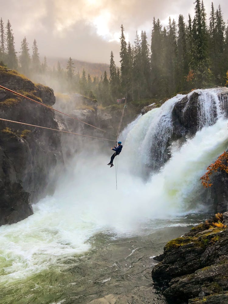 Man In Black Clothing On A Zipline