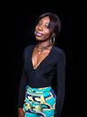 Woman in Black Long Sleeve Shirt and Blue Yellow and Green Floral Skirt