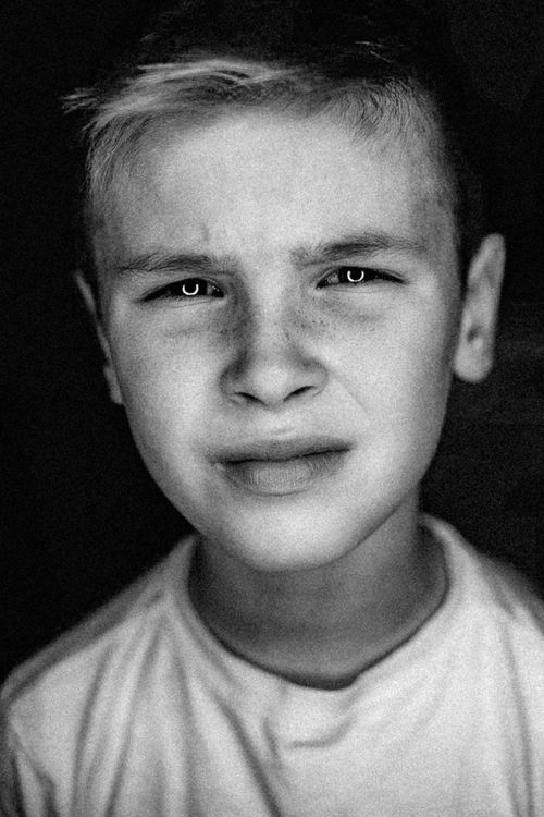 Free Emotive grayscale portrait of a pensive boy with freckles, Berlin. Stock Photo