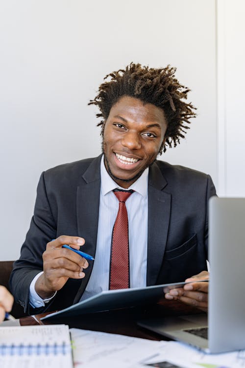 Man in Black Suit Jacket Holding a Pen 