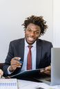 Man in Black Suit Jacket Holding Black Tablet Computer