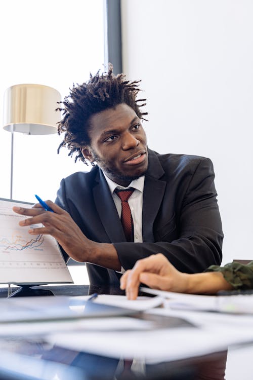 Man in Black Suit while Explaining 