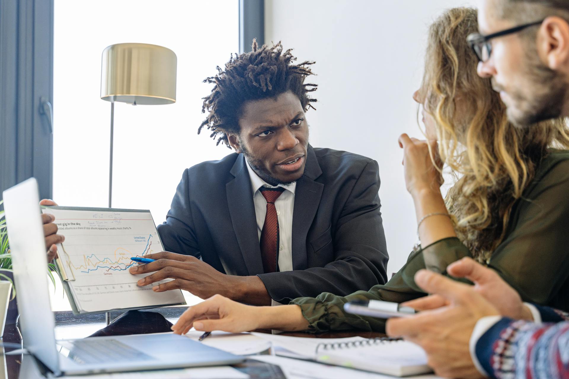 An Man in a Business Suit Talking to Clients