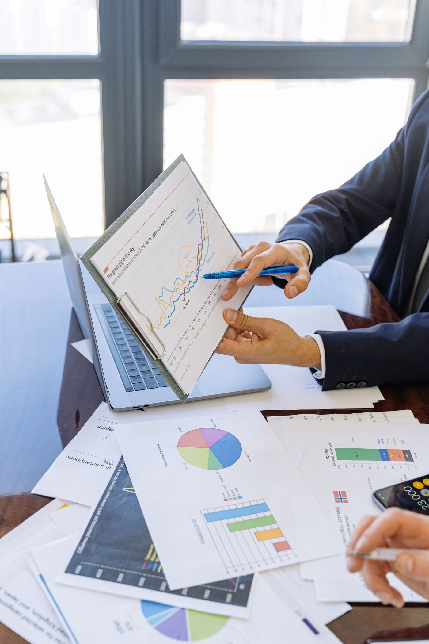 Financial charts and reports on a desk for audit and assurance review