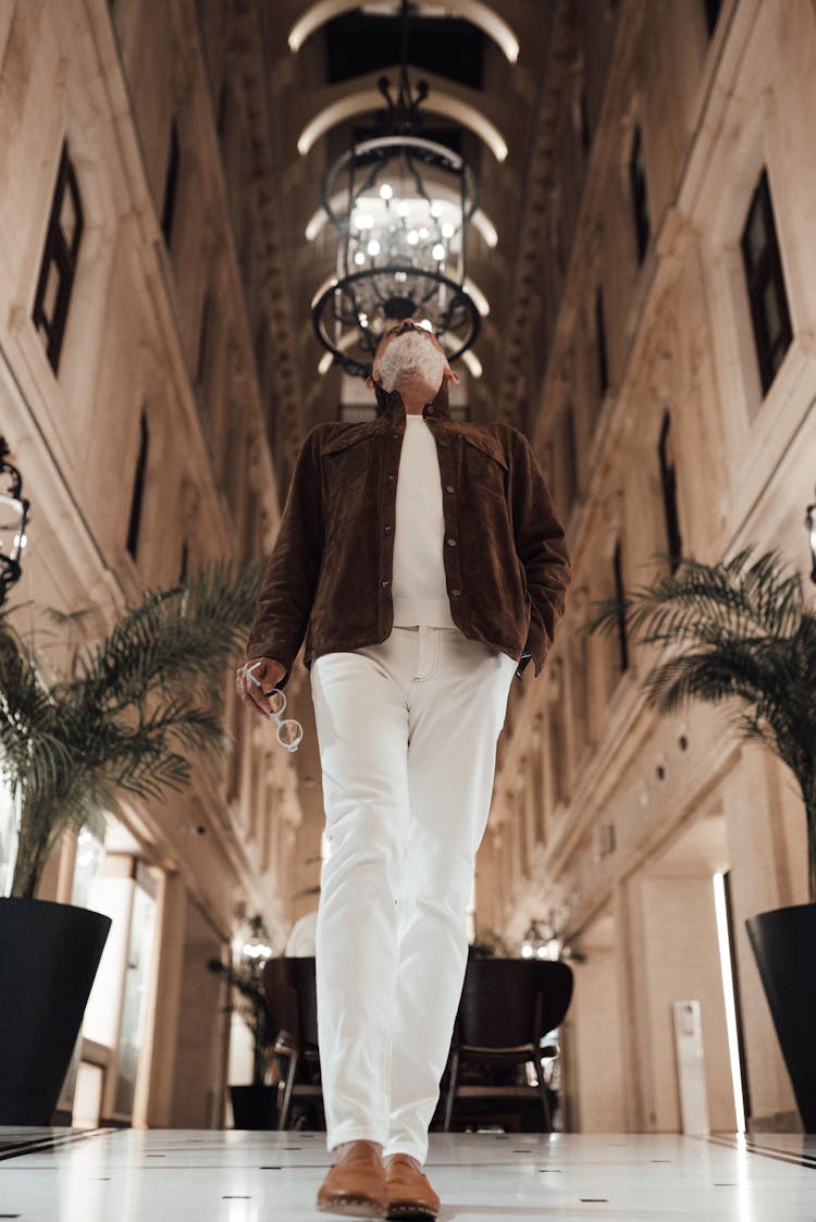 Faceless Stylish Man Looking Up In Grand Mansion Hallway