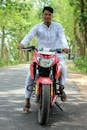 A Man Riding a Red Motorcycle