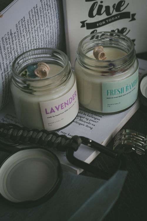 Free Cozy scene with lavender and fresh bamboo candles on an open book, creating a relaxing atmosphere. Stock Photo
