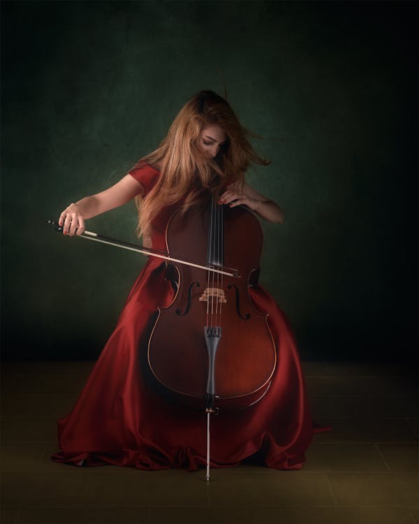 Free Woman in Red Dress Playing Cello Stock Photo