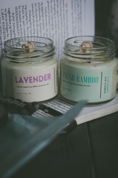 Free Close-up of lavender and bamboo scented candles in glass jars with rustic decor. Stock Photo