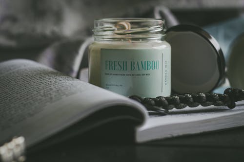 White Scented Candle On Glass Bottle