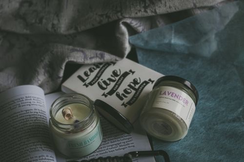 Free A cozy flat lay of scented candles, books, and inspirational quotes, perfect for relaxation. Stock Photo