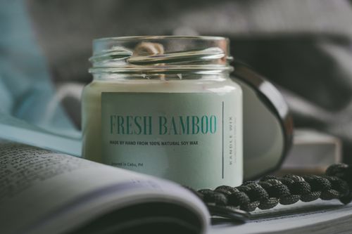Free Close-up of a soy wax candle labeled Fresh Bamboo, offering a calming home fragrance. Stock Photo