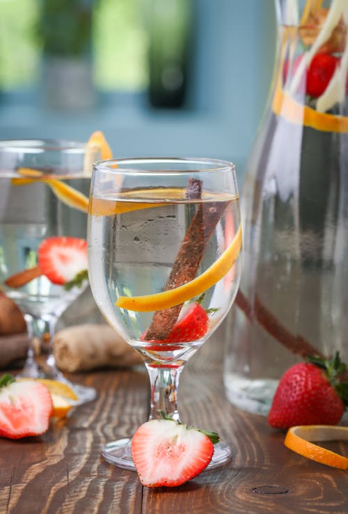 Cold Drink with Strawberry, Orange Peel and Vanilla Stick