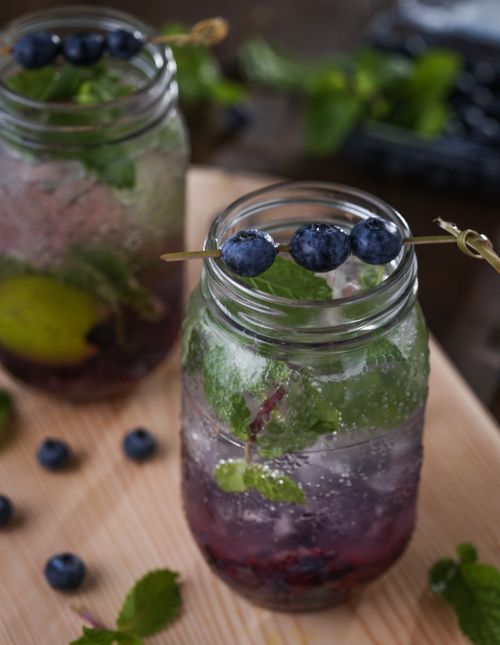 Free Delicious blueberry mint mojito served in mason jars on a wooden board. Stock Photo