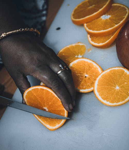 Free Person Slicing Orange Fruit  Stock Photo