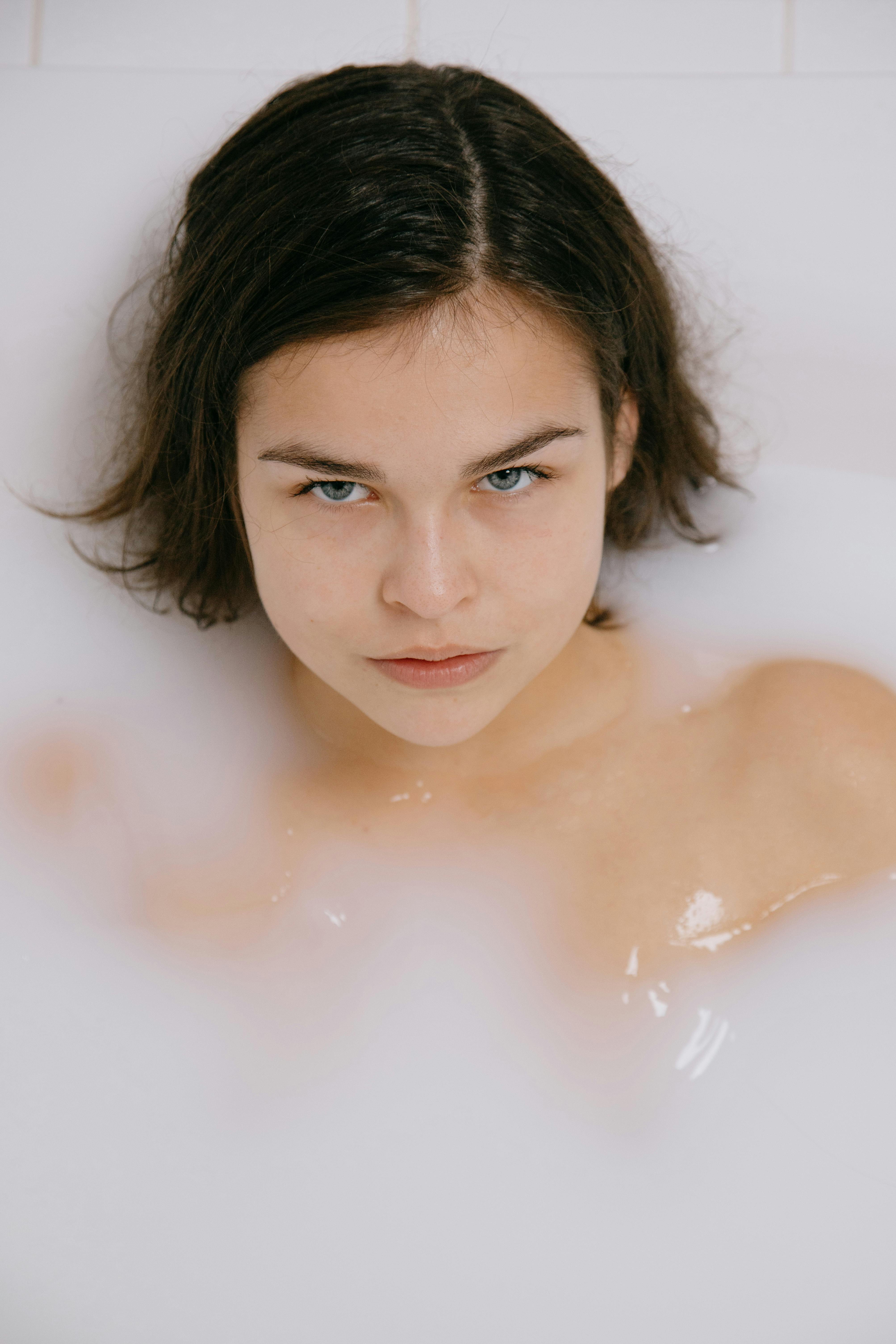 A serene woman enjoying a relaxing bath, creating a peaceful atmosphere.