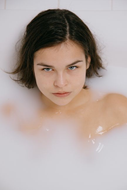 A serene woman enjoying a relaxing bath, creating a peaceful atmosphere.