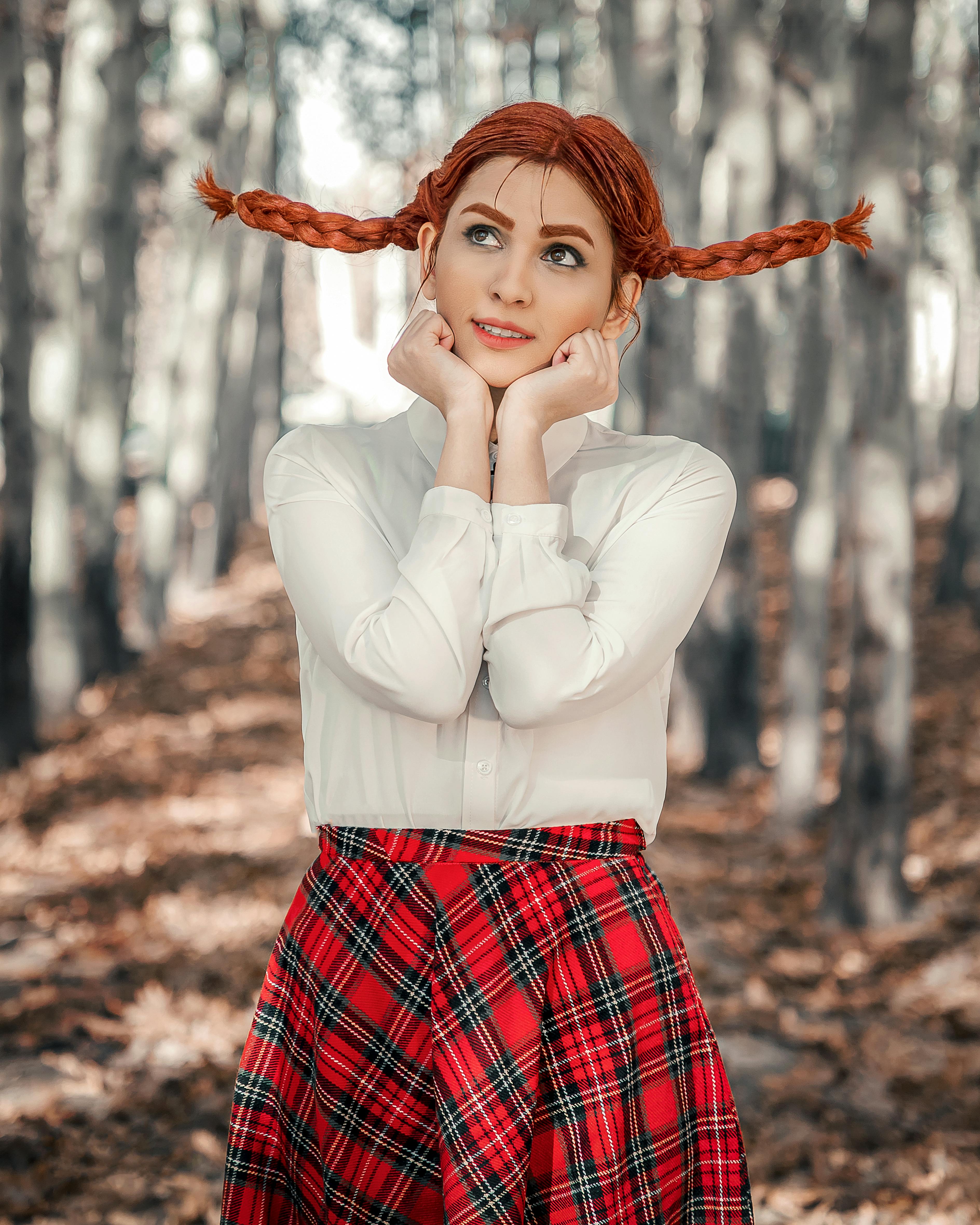 a pretty woman posing with her hands resting on her chin