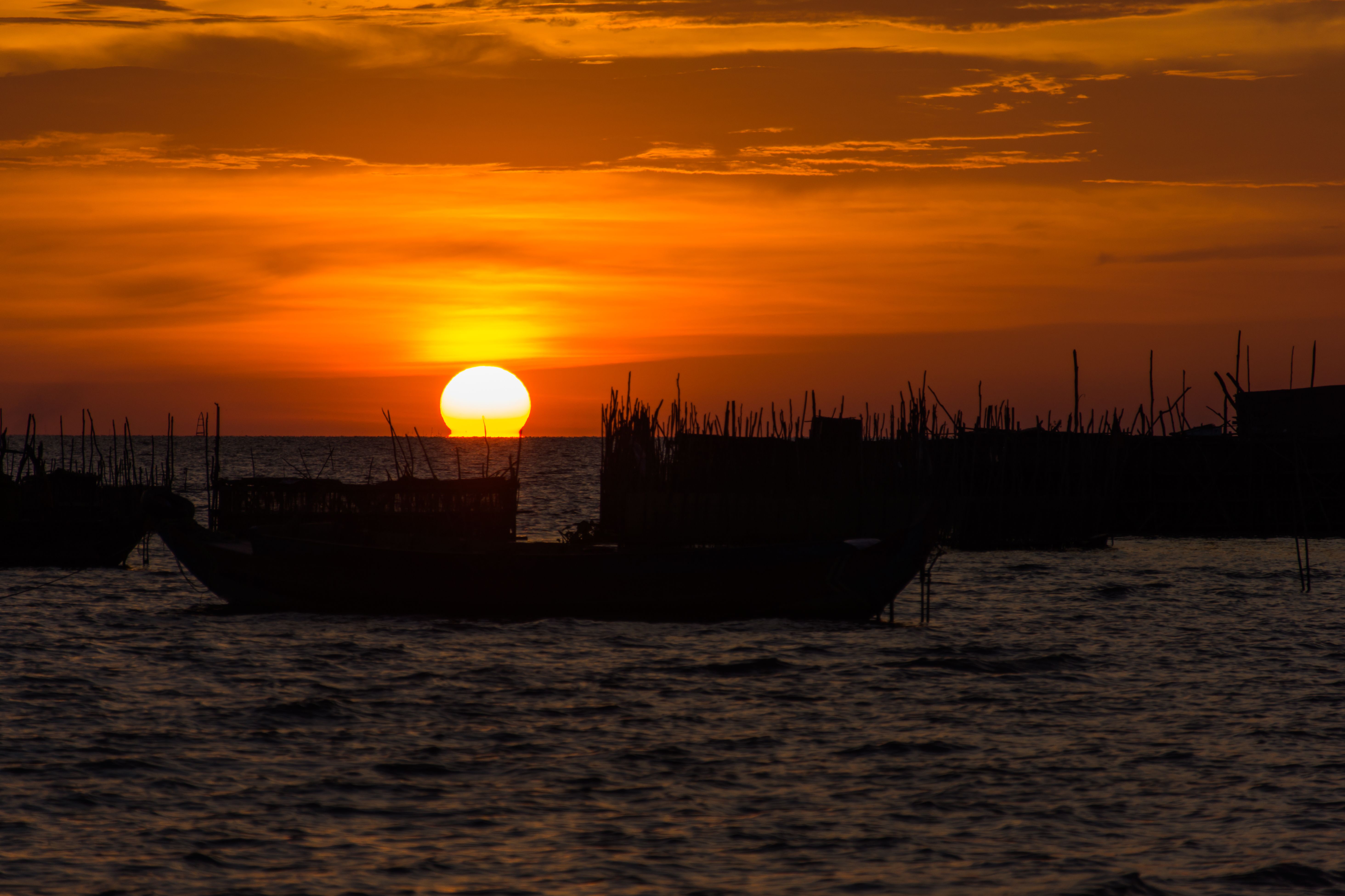 Silhouette of Boat on Sea During Sunset · Free Stock Photo