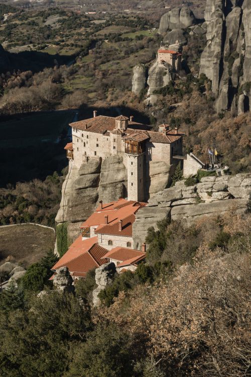 Free Stunning aerial photo of the Holy Monastery of Rousanos in Meteora, showcasing its majestic architecture amid rocky landscapes. Stock Photo