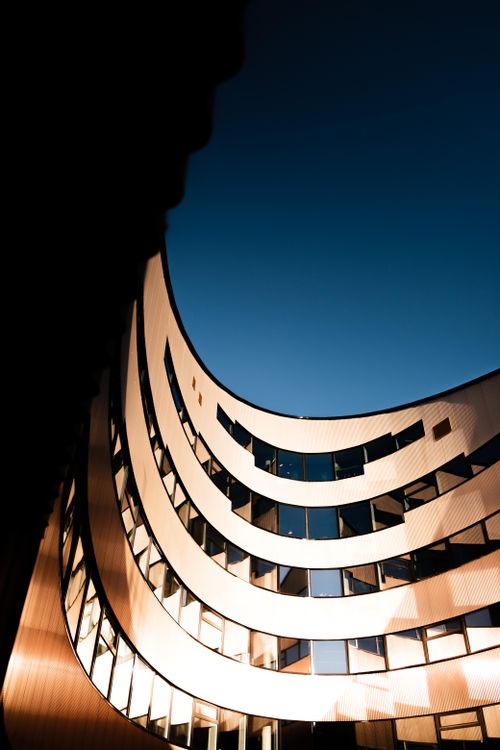 Free Dynamic view of modern architectural building in Trondheim, Norway under a clear blue sky Stock Photo