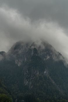 A fog-covered mountain landscape in Berchtesgaden, Germany, showcasing nature's dramatic beauty.