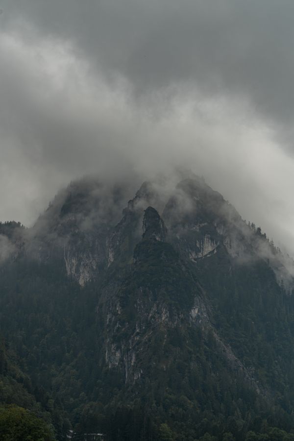 Fog banked against a steep mountainside — photo by Nico Becker on Pexels