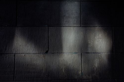 Free Black and white of background of brick wall of building with shade and light Stock Photo