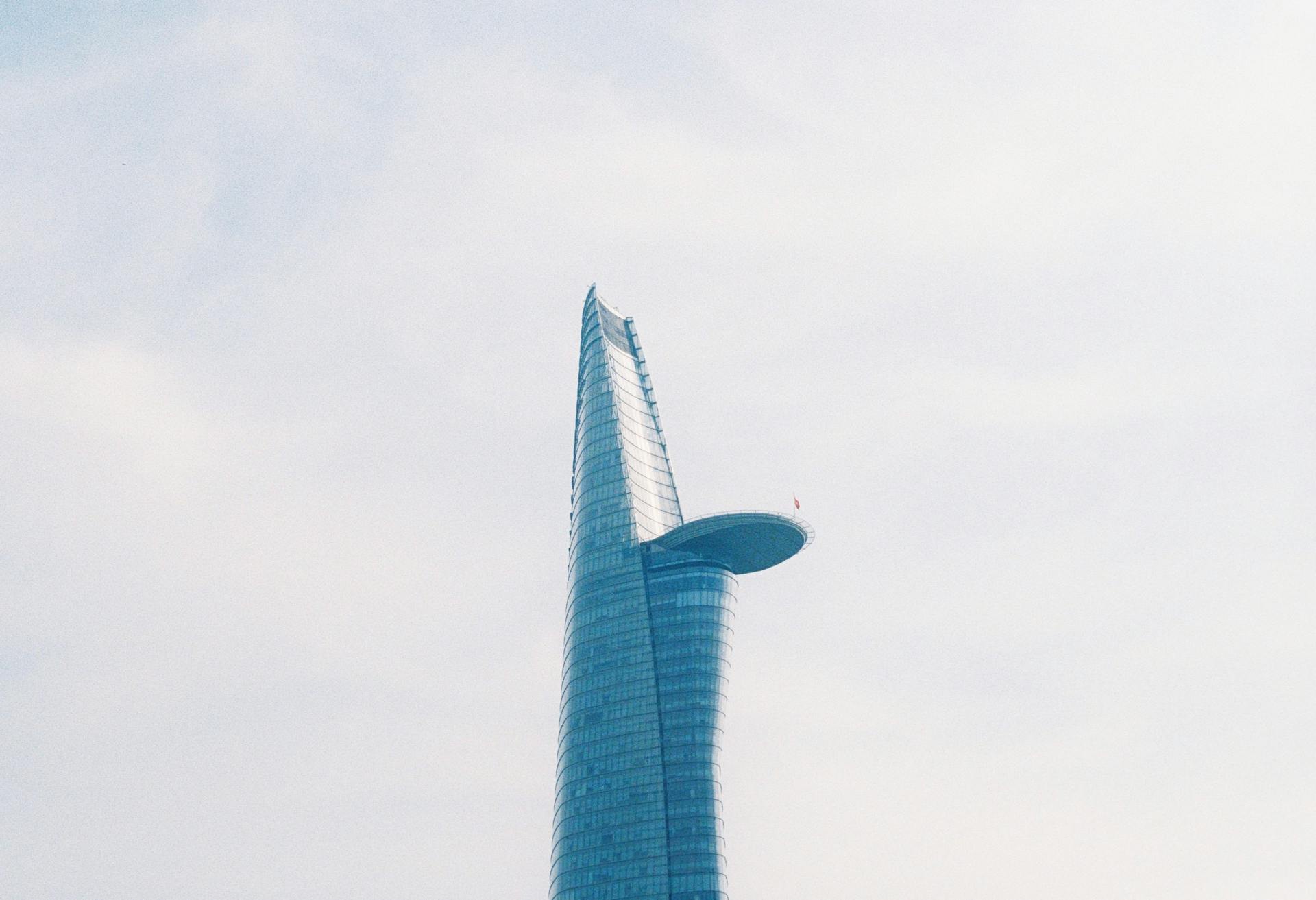 Minimalist shot of the modern Bitexco Financial Tower against a clear sky in Ho Chi Minh City, Vietnam.