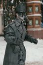 Unrecognizable person in mask and costume of plague doctor standing on street in winter