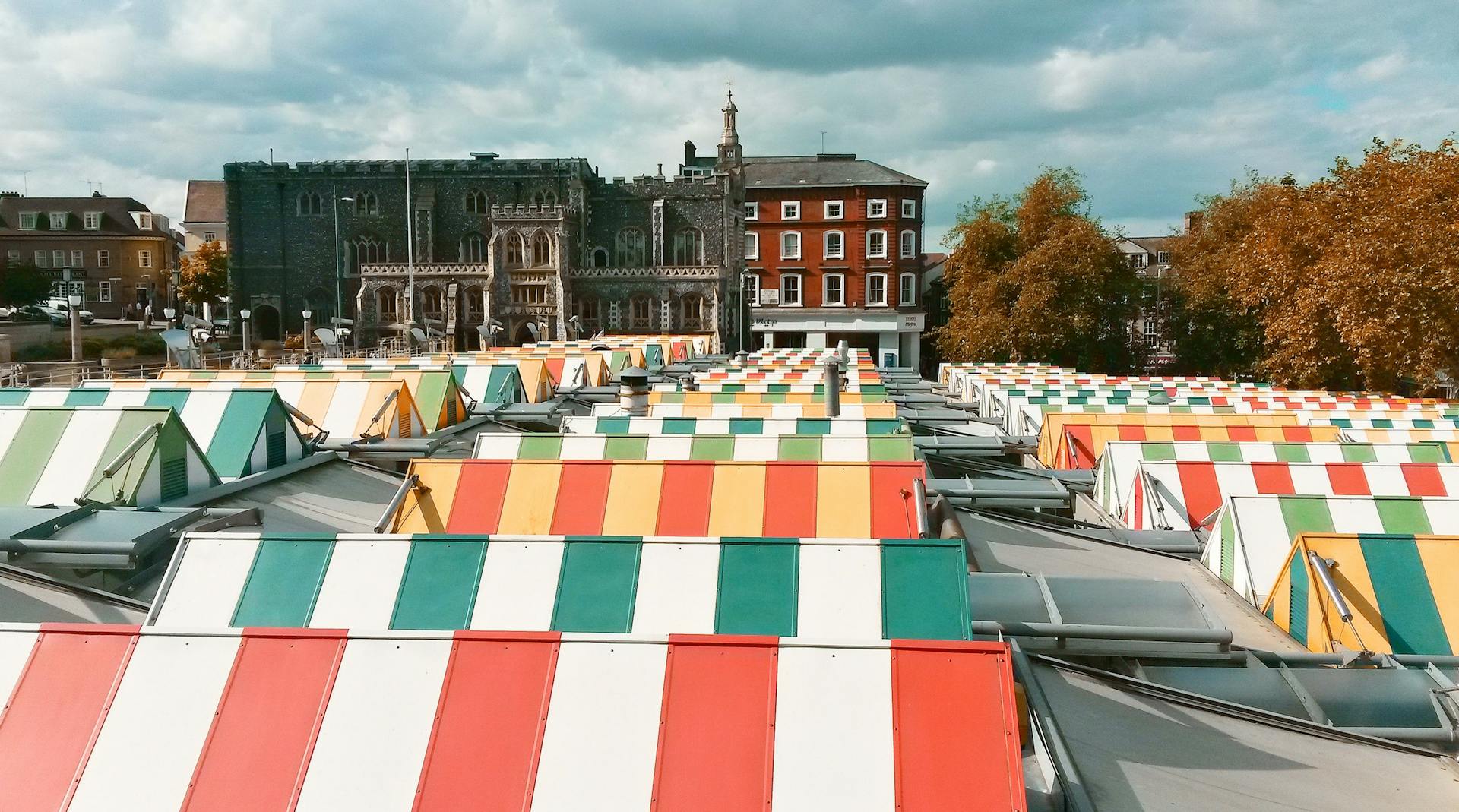 Colorful Rooftops of Norwich Market with the Medieval Church of St Peter Mancroft in the Background