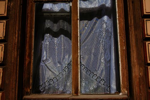 Free Exterior of aged house with curtain behind glass window with weathered timber frame Stock Photo