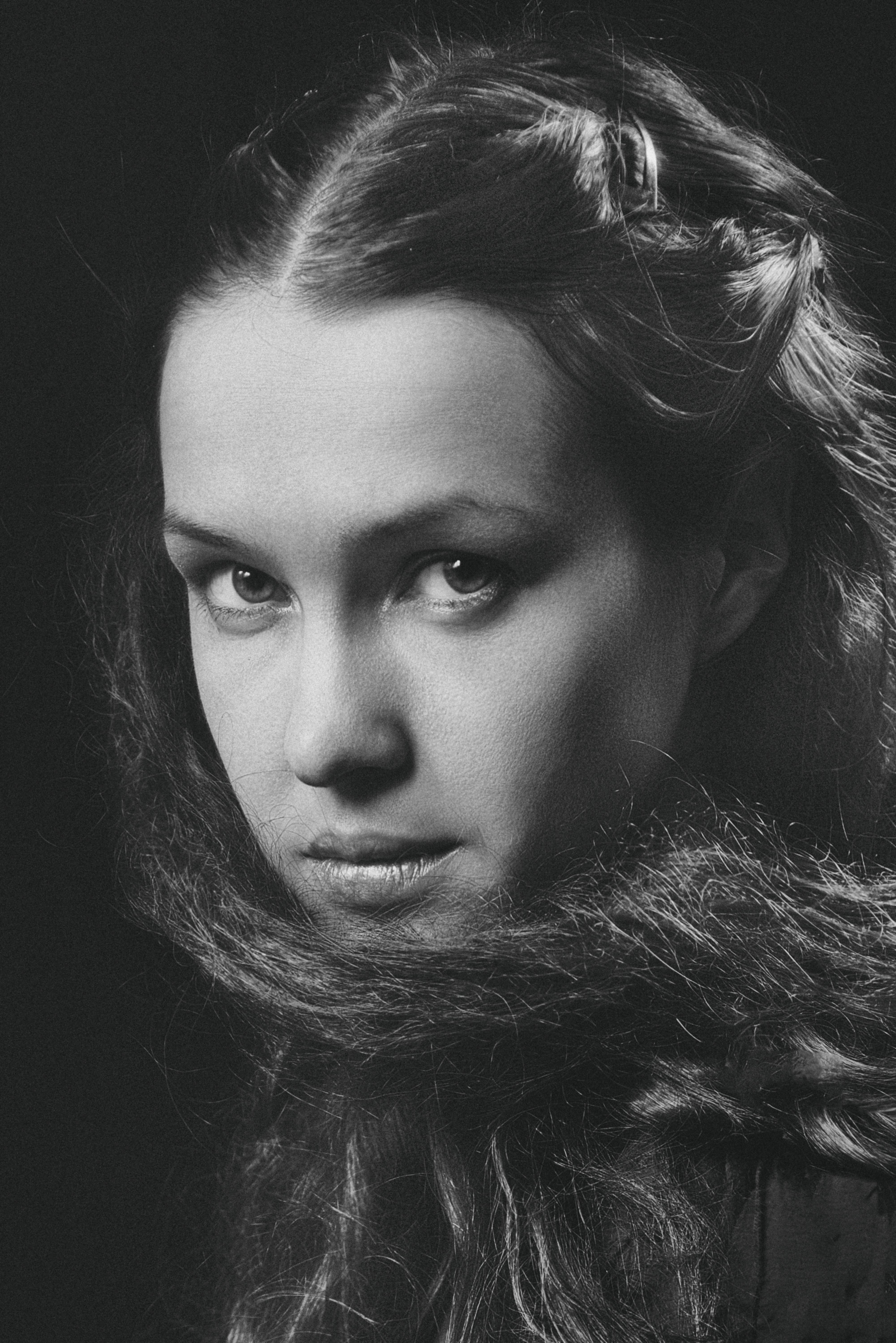 Dramatic grayscale portrait of a woman with captivating eyes.
